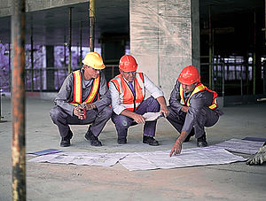 Workers and businessman on site